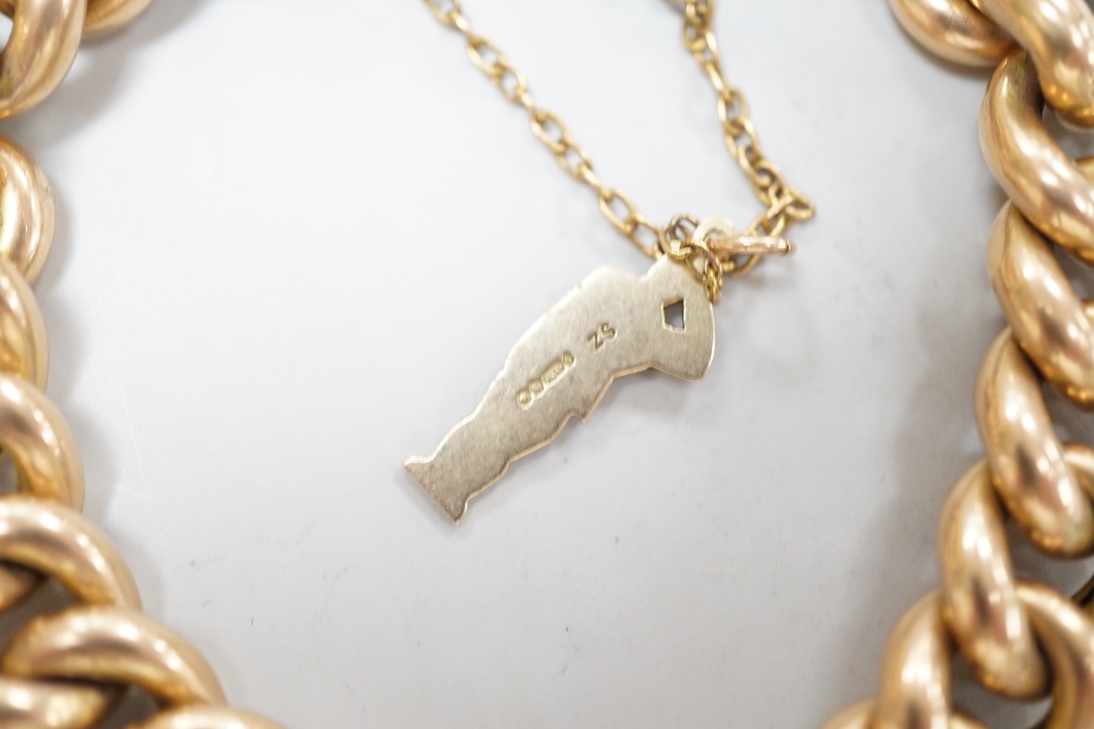 An early 20th century 15ct curb link bracelet, with later 9ct gold charm, 17cm, gross weight 26.5 grams.